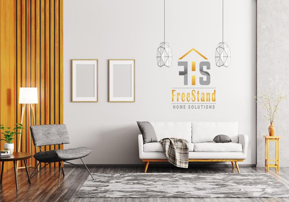 a room with a sofa, chair, and a lamp with the logo of FreeStand Home Solutions on the wall
